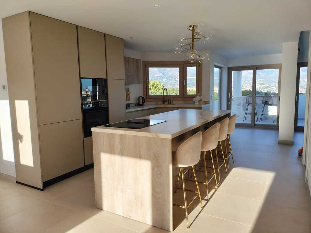 Modern kitchen renovation with cooking island and mountain view in Costa del Sol